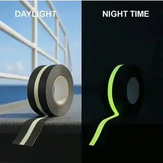 Black tape with a photoluminescent strip, pale in daylight (left) and glowing green at night (right)